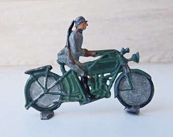Vintage lead toy soldier riding motorcycle