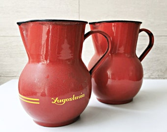 Red enamel pitchers pair made in Yugoslavia