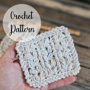 May include: A close-up of a crochet pattern with the words "Crochet Pattern" written on a white circle in the top left corner of the image.