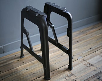 pair of symmetrical restored cast iron factory legs with rod mounts and threaded leg ends