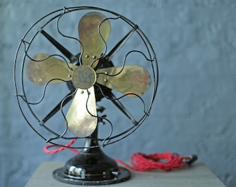 vintage oscillating cast iron base and brass blade fan by Robbins and Myers Co, circa 1920