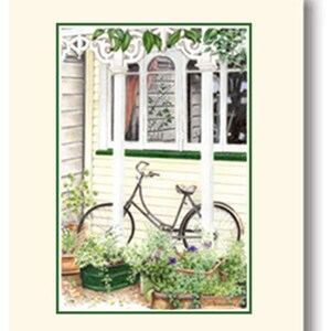 May include: A vintage bicycle is parked in front of a white house with a porch and green plants. The house has a white trim and a green roof. The bicycle is black with a brown seat and white tires.