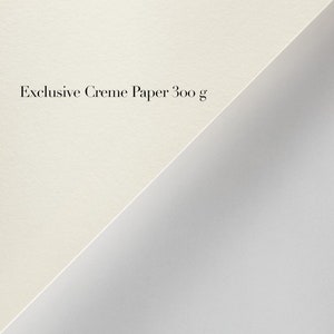 May include: Close-up of two pieces of paper, one white and one cream. The cream paper has the text "Exclusive Creme Paper 300 g" printed on it.