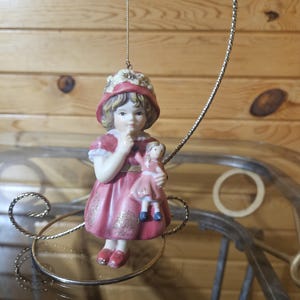 Porcelain Girl Holding Doll Ornament image 1