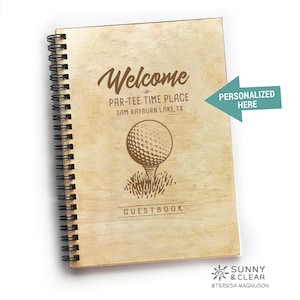 May include: A wooden guest book with a golf ball design. The text on the cover reads "Welcome to Par-Tee Time Place Sam Rayburn Lake, TX" and "Guestbook". The text "Personalized Here" is written on a separate piece of paper.
