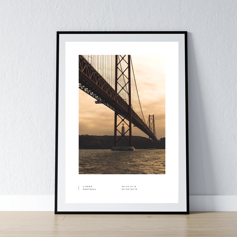 May include: A photograph of the 25 de Abril Bridge in Lisbon, Portugal. The bridge is a suspension bridge that crosses the Tagus River. The bridge is red and has a tower on each side. The photo was taken from under the bridge, looking up at the tower on the right side of the bridge.