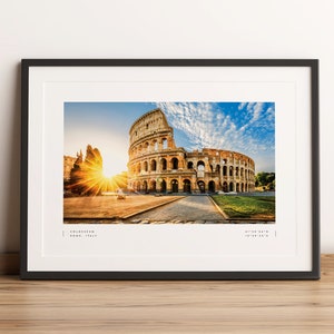 May include: A framed photograph of the Colosseum in Rome, Italy. The image shows the ancient amphitheater at sunrise with a bright sun shining through the arches. The text "COLOSSEUM ROME, ITALY" is printed below the image.