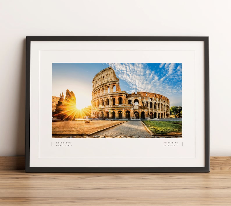 May include: A framed photograph of the Colosseum in Rome, Italy. The image shows the ancient amphitheater at sunrise with a bright sun shining through the arches. The text "COLOSSEUM ROME, ITALY" is printed below the image.