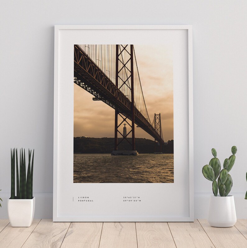 May include: A photograph of the 25 de Abril Bridge in Lisbon, Portugal. The bridge is a suspension bridge that crosses the Tagus River. The bridge is a popular tourist destination and is a symbol of the city of Lisbon.