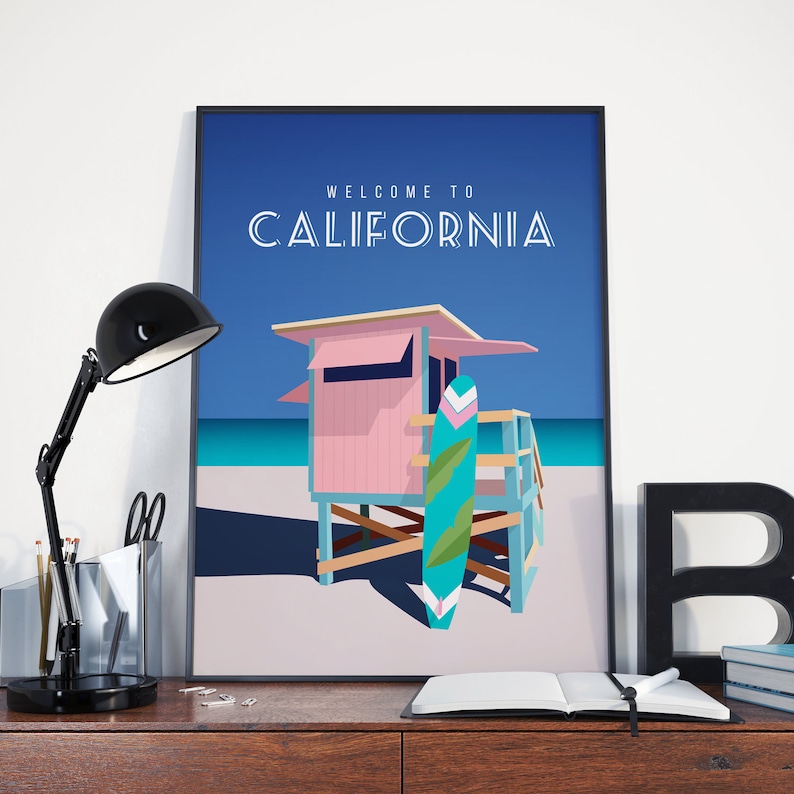 May include: A poster with a blue background and the text "WELCOME TO CALIFORNIA" in white. The poster features a pink lifeguard stand with a blue and green surfboard leaning against it. The stand is on a white sandy beach with blue ocean in the background.