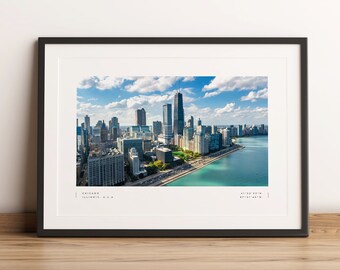 May include: An aerial view of the Chicago skyline with the Willis Tower and other skyscrapers visible. The city is situated on the edge of Lake Michigan, with blue water and a green park in the foreground.