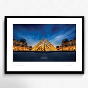 May include: A nighttime view of the Louvre Museum in Paris, France. The iconic glass pyramid is illuminated, reflecting the lights of the surrounding buildings. The sky is a deep blue with a few stars visible.