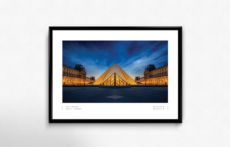 May include: A nighttime view of the Louvre Museum in Paris, France. The iconic glass pyramid is illuminated, reflecting the lights of the surrounding buildings. The sky is a deep blue with a few stars visible.