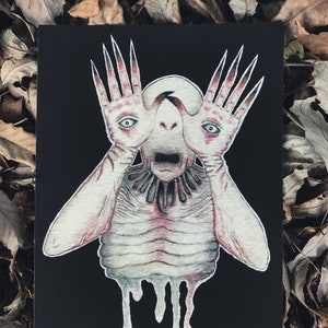 May include: A black and white drawing of a creature with long, spindly fingers and a gaping mouth. The creature is depicted with a pale, fleshy body and a dark, shadowy background.