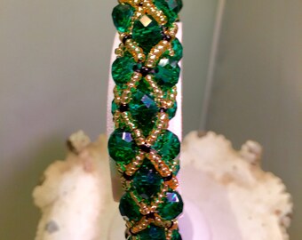 Swarovski Emerald Green 7” Netted Bracelet.  Galvanized Gold Plated, Jet Black Seed Beads. Gold Plated Lobster Clasp With Extender Chain.