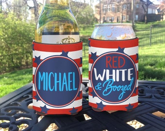 May include: Two red, white, and blue can coolers. One cooler has the name "MICHAEL" in a blue circle with white stars. The other cooler has the text "RED WHITE & Boozed" in a blue circle with white stars.
