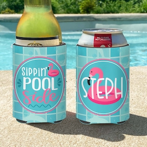 May include: Two blue and white can coolers with a flamingo pool float design. One cooler says "Sippin' Pool Side" and the other says "Steph".