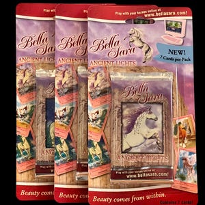 May include: Multiple packs of Bella Sara Ancient Lights trading cards. Each pack features a white horse with a purple mane and the text "Bella Sara". The packaging is red and purple with images of horses and the text "Beauty comes from within."