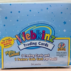 May include: A sealed box of Webkinz Trading Cards. The box is light blue with a star pattern and features the Webkinz logo. Text on the box includes "Trading Cards", "5 Trading Cards and 1 Feature Code Card Per Pack!", and "36 packs".