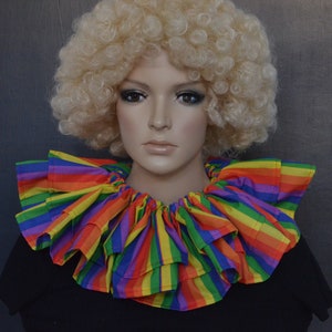 May include: A rainbow striped ruffled collar with multiple layers. The collar is made of a soft, lightweight fabric and is perfect for adding a touch of whimsy to any outfit.