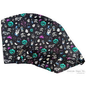May include: Black fabric head wrap with a repeating pattern of green apples, crowns, and other symbols. The text "Custom Caps Co." is printed in the bottom right corner.