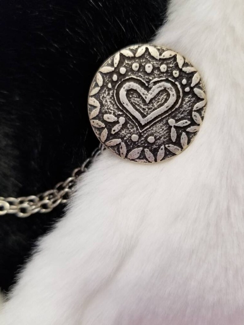 color- silverblack size is approximately half dollar Cloak clasps