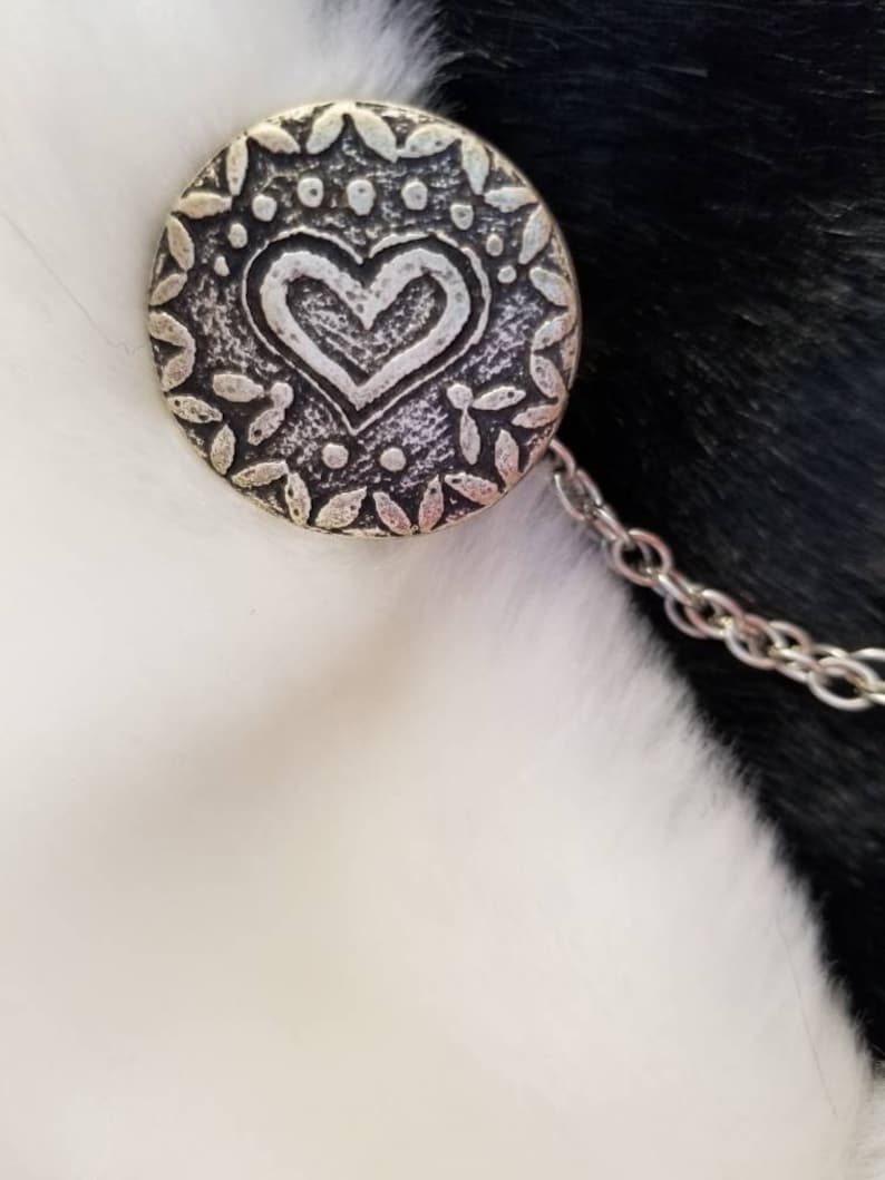 color- silverblack size is approximately half dollar Cloak clasps