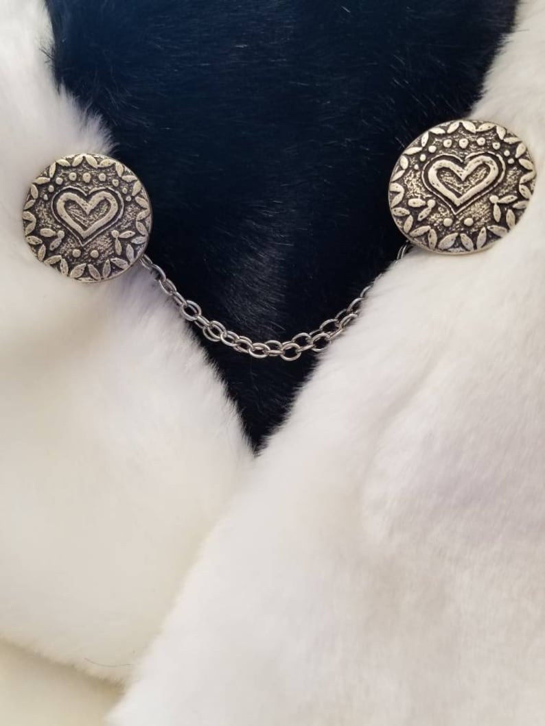 color- silverblack size is approximately half dollar Cloak clasps
