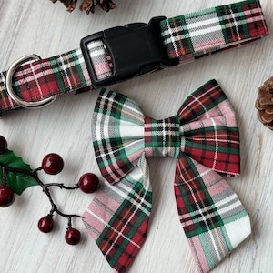 May include: A red, green, and white plaid dog collar and matching bow tie. The collar has a black plastic buckle.