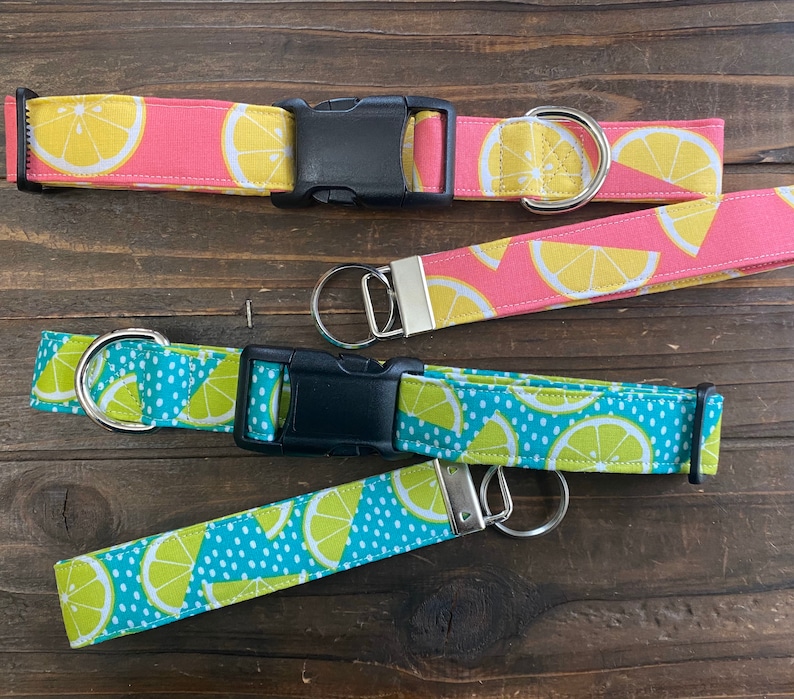 May include: Three dog collars with lemon print fabric. The collars are in pink, blue and green with white polka dots. The collars have black buckles and silver rings.