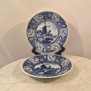 Vintage Beautiful BOCH Pottery “DELFTS” Windmill Two Decorative Wall Plates. White  And Blue, Flowers, Leaves Rim. Made In Holland.