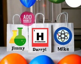 May include: Three white paper gift bags with handles. The bags have different science-themed designs: beakers, a periodic table element, and an atom. The bags are labeled with the names "Jimmy", "Darryl", and "Mike".