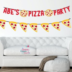 May include: A red and yellow banner with the text "ABE'S PIZZA PARTY" and pizza slice illustrations. The banner is hanging on a white wall above a white sofa.