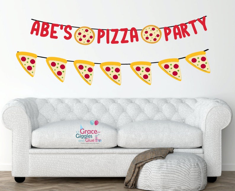 May include: A red and yellow banner with the text "ABE'S PIZZA PARTY" and pizza slice illustrations. The banner is hanging on a white wall above a white sofa.