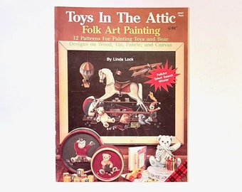 May include: Book cover featuring a painting of toys in an attic. The book title is "Toys In The Attic Folk Art Painting" and the subtitle is "12 Patterns For Painting Toys and Bear Designs on Wood, Tin, Fabric, and Canvas". The book is by Linda Lock.