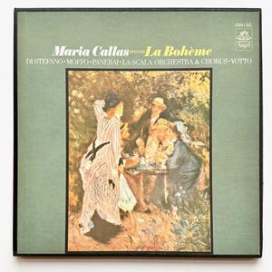 May include: Vintage vinyl record album cover for Maria Callas' performance of Puccini's La Bohème. The album cover features a painting of a group of people in a garden setting. The album title and artist's name are printed in white and black text.