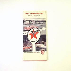 May include: A vintage Texaco road map for Pittsburgh and vicinity. The map features a red star with a white "T" in the center, surrounded by images of cars and a Texaco gas station.