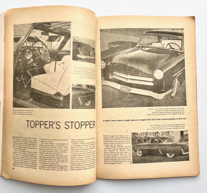 May include: A black and white photo of a 1950s era custom car. The car has a chrome bumper, a black grille, and a white roof. The car is parked on a street. The text "Topper's Stopper" is printed in large letters at the bottom of the page.