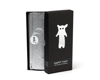 May include: A black box with a silver mirror shape of a bear on the front. The box is open, revealing tissue paper and a sticker that says "edu." The text "FOREST TALES Mirror shapes for storytelling" is printed on the front of the box.