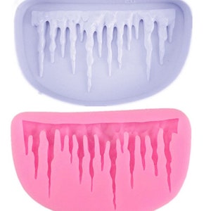 May include: Two silicone moulds for making icicles. The top mould is light purple and the bottom mould is pink.