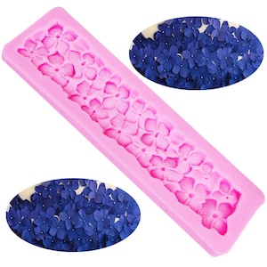 May include: Pink silicone mold with a design of a row of small flowers. The mold is used to create decorative sugar flowers for cakes and other desserts.