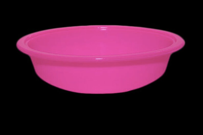 May include: A bright pink plastic bowl. The bowl is round and has a smooth surface.