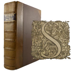 May include: A vintage book with a brown leather cover and gold lettering. The spine reads "NOVUM TESTAMENTUM GRAECUM BIBLIA HEBRAICA" and the year 1619 is visible. An ornate letter "S" illustration is next to the book.