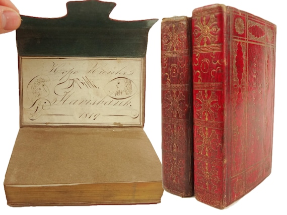 1812 Holy Bible. With delightful manuscript bookplates. Wallet-style straight-grain morocco bindings, richly decorated in gilt.