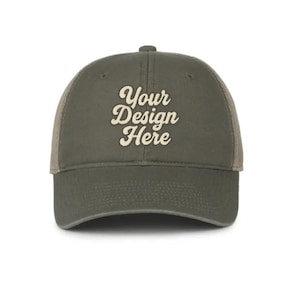 May include: Olive green trucker hat with the text "Your Design Here" in a cream-colored script. The hat features a mesh back and a curved brim, suitable for casual wear.