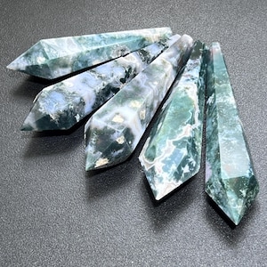 May include: Six green, white, and gray moss agate crystal points. The points are polished and have a smooth, glassy finish.