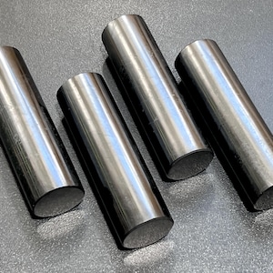 Peut inclure: Quatre tiges métalliques noires avec des extrémités arrondies. Les tiges sont disposées en rangée, les extrémités des tiges pointant dans différentes directions.
