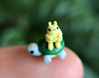 Yellow bug and green turtle figurine