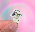 Tiny cat UFO sticker, vinyl waterproof, white alien kitty driving a spaceship, holographic sparkle