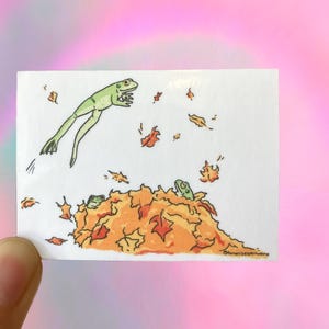 Autumn frogs illustrated sticker, animals jumping into leaves, fall drawing, forest creature art